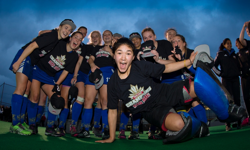 University of British Columbia Thunderbird goalkeeper Rowan Harris jumps in for a team photo following a 3-2 victory (3-1 in penalty shots) over the University of Victoria Vikes in the gold medal match of the CIS Women's Field Hockey Championships claiming their fifth straight McCrae Cup on November 8th, 2015 in Victoria, British Columbia, Canada.